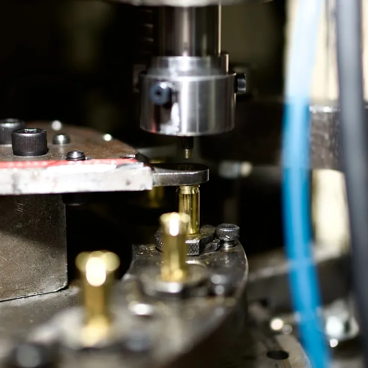 Digital caliper measuring a precision brass component